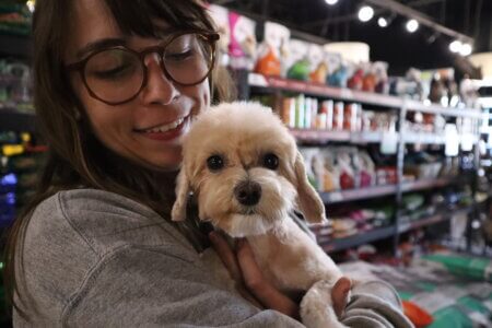 A Doggy Daze staff member loving on one of our precious fur babies
